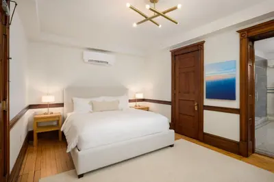 a bedroom with a white bed and a ceiling fan at Wilbur Mansion in Bethlehem