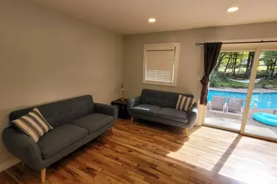 a living room with two couches and a pool at Large Vacation Home Villa- Pool, Indoor Hotub, Game Room, up to 25 guests in Monticello