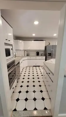 a white kitchen with a black and white tiled floor at Large Vacation Home Villa- Pool, Indoor Hotub, Game Room, up to 25 guests in Monticello