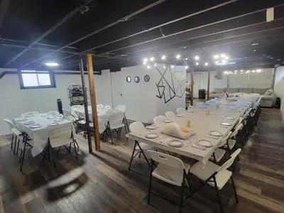 a long table with white tables and chairs in a room at Large Vacation Home Villa- Pool, Indoor Hotub, Game Room, up to 25 guests in Monticello