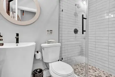 a bathroom with a toilet and a sink and a mirror at Chimney Hill Estate Inn in Lambertville