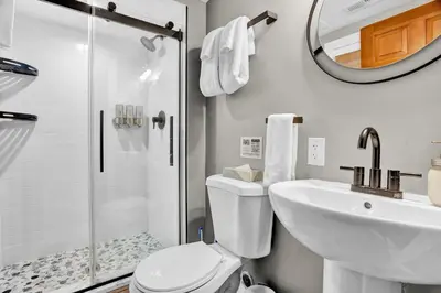 a bathroom with a toilet and a sink and a shower at Chimney Hill Estate Inn in Lambertville