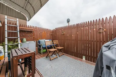 a patio with a fence and a table and chairs at Bedroom in thoughtfully decorated East Passyunk home (South Philadelphia) in Philadelphia