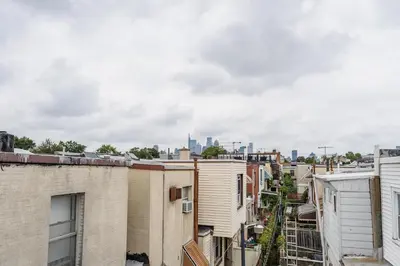 a view of the city from the roofs of buildings at Bedroom in thoughtfully decorated East Passyunk home (South Philadelphia) in Philadelphia