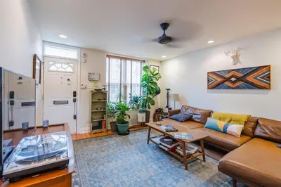 a living room with a couch and a table at Bedroom in thoughtfully decorated East Passyunk home (South Philadelphia) in Philadelphia