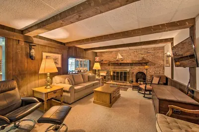 a living room with a couch and a fireplace at Amish Country Apartment with Cozy Fireplace! in New Holland