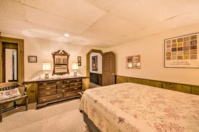 a bedroom with a bed and a dresser and a mirror at Amish Country Apartment with Cozy Fireplace! in New Holland
