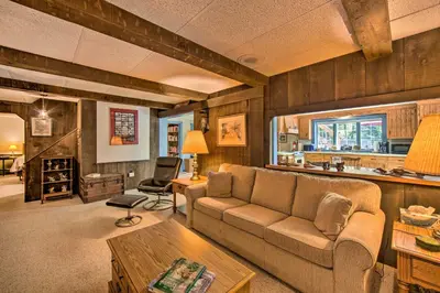 a living room with a couch and a table at Amish Country Apartment with Cozy Fireplace! in New Holland