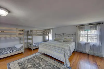 a bedroom with two bunk beds and a rug at 3-Acre Property Charming Dutch Country Colonial in Reading