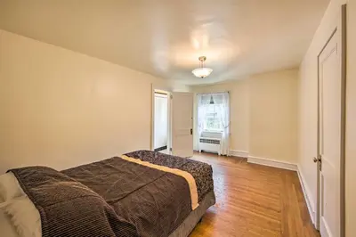 an empty bedroom with a bed and a window at 3-Acre Property Charming Dutch Country Colonial in Reading