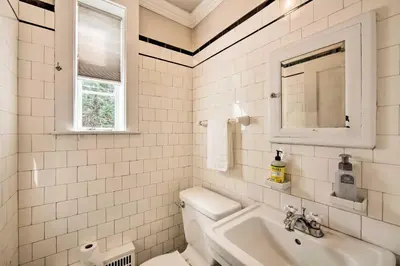 a white bathroom with a sink and a toilet at 3-Acre Property Charming Dutch Country Colonial in Reading