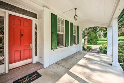 a red front door of a white house at 3-Acre Property Charming Dutch Country Colonial in Reading