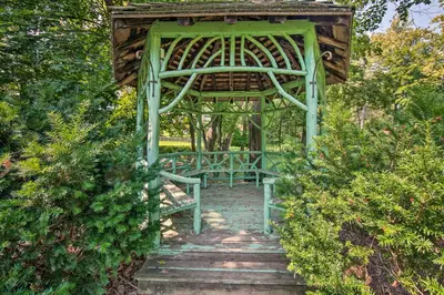 a green gazebo in a garden with a pathway at 3-Acre Property Charming Dutch Country Colonial in Reading