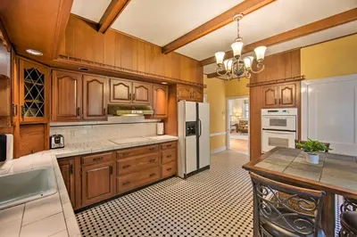 a kitchen with wooden cabinets and a white refrigerator at 3-Acre Property Charming Dutch Country Colonial in Reading