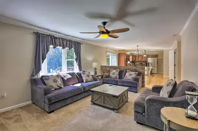 a living room with couches and a ceiling fan at Hot Tub, Fire Pit and Lake Access Poconos Escape! in Albrightsville