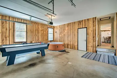 a pool table in a room with wooden walls at Charming Lewisburg Home with Hot Tub and Games! in Lewisburg