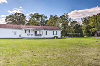 an old white house with a soccer field at Charming Lewisburg Home with Hot Tub and Games! in Lewisburg