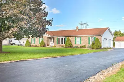 a house with a driveway in front of it at Charming Lewisburg Home with Hot Tub and Games! in Lewisburg