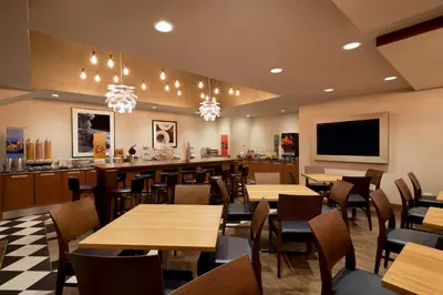 a restaurant with tables and chairs and a bar at Hampton Inn Manhattan/Downtown- Financial District in New York