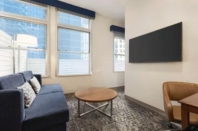 a living room with a couch and a tv at Hampton Inn Manhattan/Downtown- Financial District in New York