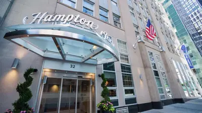 a building with a sign on the front of it at Hampton Inn Manhattan/Downtown- Financial District in New York