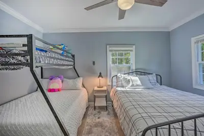 a bedroom with two bunk beds and a window at Stunning South Fallsburg Home with Pool and Deck! in South Fallsburg
