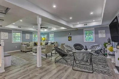 a living room with a couch and a table and chairs at Stunning South Fallsburg Home with Pool and Deck! in South Fallsburg