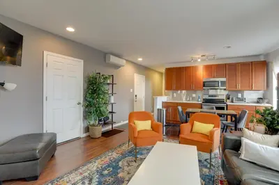 a living room with a couch and chairs and a kitchen at Philadelphia Apartment, Near Transit and Sites! in Philadelphia