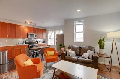 a living room with a couch and a table at Philadelphia Apartment, Near Transit and Sites! in Philadelphia