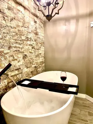 a bath tub with a glass of wine in a bathroom at Big Boulder Lake and Ski!!!! in Lake Harmony