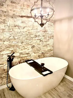 a bathroom with a white bath tub and a chandelier at Big Boulder Lake and Ski!!!! in Lake Harmony
