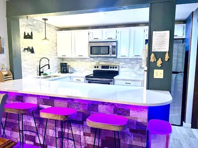 a kitchen with purple stools and a counter top at Big Boulder Lake and Ski!!!! in Lake Harmony
