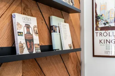 a book shelf with three books on it at A newly built Tiny House in the center of Historic Kennett Square in Kennett Square