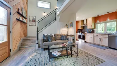 a living room with a couch and a stairway at A newly built Tiny House in the center of Historic Kennett Square in Kennett Square