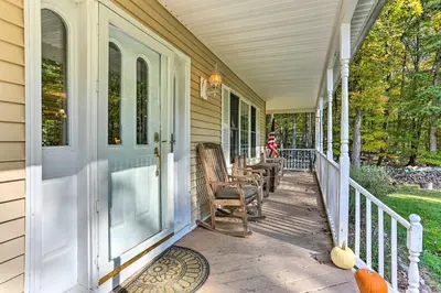 a porch of a house with rocking chairs on it at Pet-Friendly Grand Pine Bush Retreat on 2 Acres! in Pine Bush