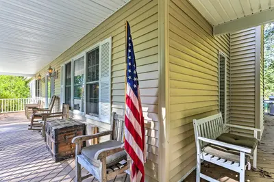 an american flag on the front porch of a house at Pet-Friendly Grand Pine Bush Retreat on 2 Acres! in Pine Bush