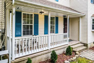 a house with a porch with chairs on it at Tree and Easy in Tobyhanna