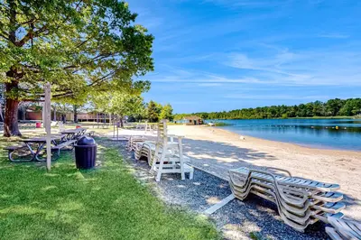 a row of benches on the shore of a lake at Tree and Easy in Tobyhanna