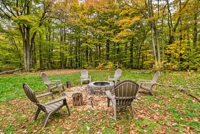 a group of chairs sitting around a fire pit at 12 Mi to Camelback Ski Resort Home with Decks! in Tobyhanna
