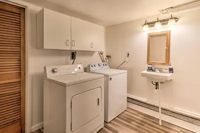 a small laundry room with a washer and dryer at 12 Mi to Camelback Ski Resort Home with Decks! in Tobyhanna