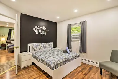 a bedroom with a bed and a chair and a window at 12 Mi to Camelback Ski Resort Home with Decks! in Tobyhanna
