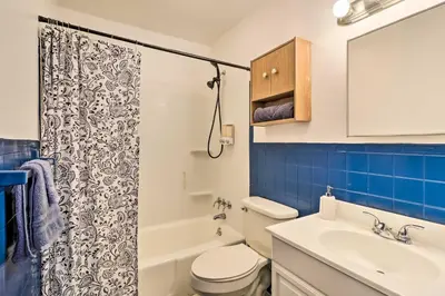 a bathroom with a toilet and a sink and a shower at 12 Mi to Camelback Ski Resort Home with Decks! in Tobyhanna