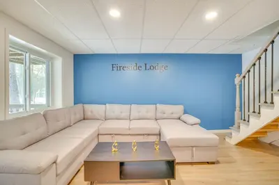 a living room with a white couch and a blue wall at Less Than 7 Mi to Slopes Inviting Pocono Mtn Retreat! in Albrightsville
