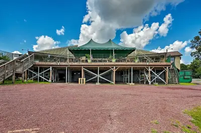 a large building with a green roof and a porch at Less Than 7 Mi to Slopes Inviting Pocono Mtn Retreat! in Albrightsville