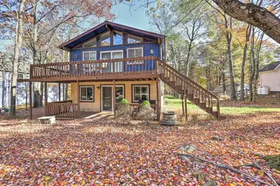 a blue house with a deck on a pile of leaves at Less Than 7 Mi to Slopes Inviting Pocono Mtn Retreat! in Albrightsville