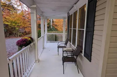 a porch of a house with chairs and a window at Luxury 4 bedroom house in Pocono Mountains with Hottub in Golf Course Near Lake in Tobyhanna