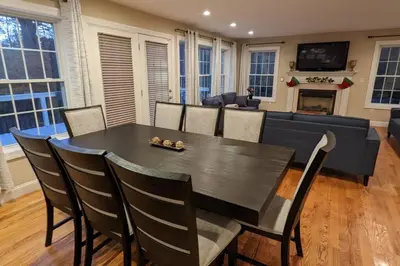 a dining room with a black table and chairs at Luxury 4 bedroom house in Pocono Mountains with Hottub in Golf Course Near Lake in Tobyhanna