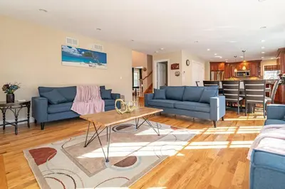 a living room with blue couches and a table at Luxury 4 bedroom house in Pocono Mountains with Hottub in Golf Course Near Lake in Tobyhanna