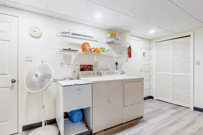 a kitchen with white appliances and a fan at Big Boulder Base Camp in Lake Harmony