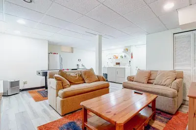 a living room with two couches and a table at Big Boulder Base Camp in Lake Harmony